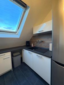 a kitchen with a sink and a window in it at Ferienwohnung Victoria in Recklinghausen +7 photos