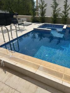 a large swimming pool with blue water at Villa Richard in Sutomore