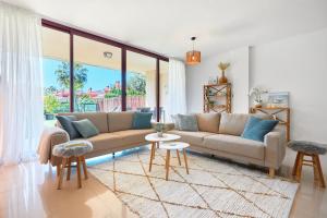 a living room with a couch and a large window at Charming Bungalow in Venta Lanuza - by Welcomely in El Campello