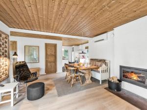 a living room with a table and a fireplace at Holiday Home Magrete - 900m from the sea by Interhome in Blåvand