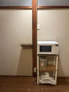 a microwave on a shelf in a room at Chikotto Inn in Kumano +9 photos