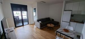 a small living room with a couch and a kitchen at Park Vila apartment in Belgrade