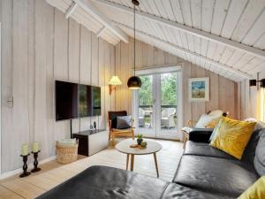 a living room with a couch and a table at Holiday Home Rumena - 800m from the sea by Interhome in Blåvand