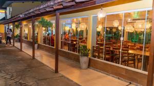 a restaurant with tables and chairs inside of it at Pousada Itajuípe- Unidade Itabuna-Ba in Itabuna