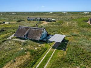 an old house in a field with a solar panel at Holiday Home Klimentina - 150m from the sea by Interhome in Ringkøbing +25 photos
