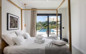 a bedroom with a large white bed with towels on it at Villa OX by Villas Guide in Brajkovići +27 photos