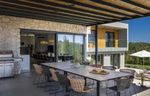 an outdoor patio with a table and chairs at Villa OX by Villas Guide in Brajkovići