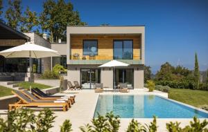 a villa with a swimming pool and a house at Villa OX by Villas Guide in Brajkovići