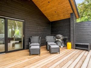 a patio with chairs and a star wars droid on it at Holiday Home Edmond - 995m from the sea by Interhome in Ringkøbing