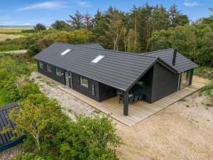 an overhead view of a black house with a deck at Holiday Home Edmond - 995m from the sea by Interhome in Ringkøbing +32 photos