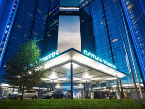 a large building with cars parked in front of it at Gothia Towers & Upper House in Gothenburg