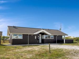 a house with a black exterior at Holiday Home Thrugot - from the sea by Interhome in Bjerregård