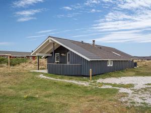 a gray house with a gambrel roof at Holiday Home Estella - 500m to the fjord by Interhome in Havrvig