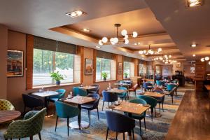 a dining room filled with tables and chairs at Thistle London Hyde Park Kensington Gardens in London