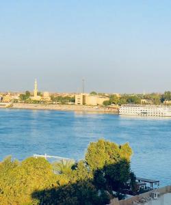 a view of a river with a city in the background at pradise house holday in Banī Ghālib