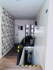 a hallway with a staircase with yellow and black stripes at Majestic Hostel Porto in Porto