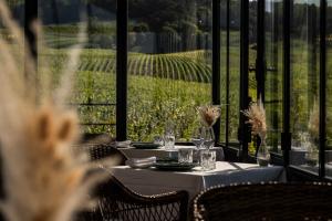 a table with wine glasses and a view of a vineyard at Chateau de Sacy in Sacy