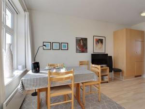 a dining room with a table and chairs in a room at Holiday Home Ena - 75m from the sea by Interhome in Lemvig