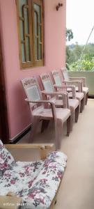 a row of chairs in a room with a window at Dinu Homes Stay in Haputale