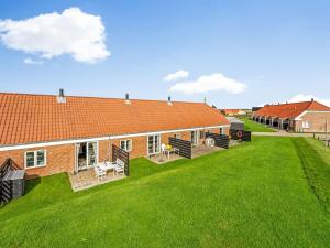 a house with a green lawn in front of it at Apartment Smeralda - 200m from the sea by Interhome in Lemvig +24 photos