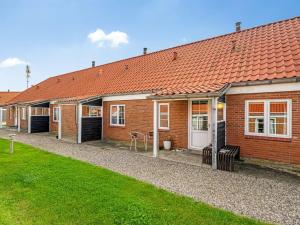 a row of brick houses with a green yard at Apartment Smeralda - 200m from the sea by Interhome in Lemvig
