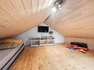a room with a bed and a flat screen tv at Holiday Home Benthe - from the sea by Interhome in Ulfborg +44 photos