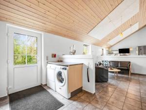 a kitchen with a washing machine in a room at Holiday Home Benthe - from the sea by Interhome in Ulfborg