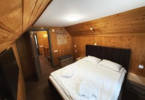 a bedroom with a large bed in a wooden room at Casa Familiei in Braşov +20 photos