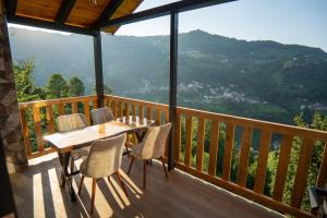 a table and chairs on a balcony with a view at Nayoni Suit Bungalov in Çamlıhemşin +12 photos