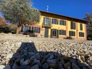 a large pile of rocks in front of a building at Charming Italian Home sleeps 6 Cantarana in Cantarana