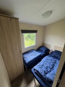 a small bedroom with a bed and a window at RBR 166 - Beach Resort Kamperland in Kamperland +9 photos