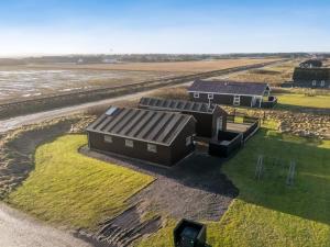 an aerial view of two buildings on a field at Holiday Home Damaskin - 300m from the sea by Interhome in Harboør +27 photos