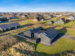 an aerial view of a house with solar panels on it at Holiday Home Damaskin - 300m from the sea by Interhome in Harboør