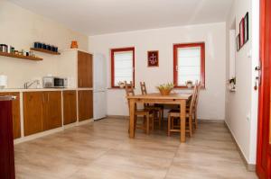 a kitchen and dining room with a table and chairs at Bed & Fishing House in Slap ob Idrijci