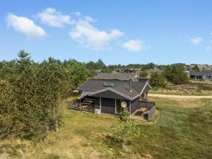 an aerial view of a house in a field at Holiday Home Chumani - 900m from the sea by Interhome in Torsted
