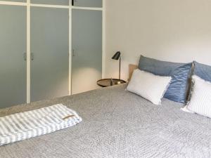 a bedroom with a bed with two pillows on it at Holiday Home Flor - 900m from the sea by Interhome in Torsted