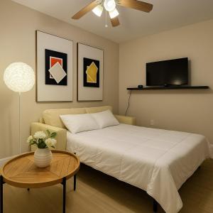 a bedroom with a bed and a table and a tv at Downtown Miami full apartment with kitchen in Miami
