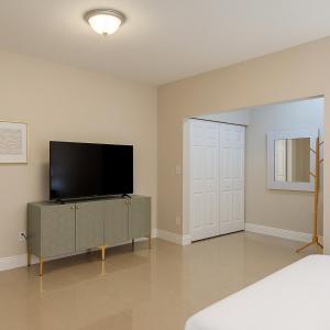 a bedroom with a flat screen tv sitting on a cabinet at Downtown Miami full apartment with kitchen in Miami