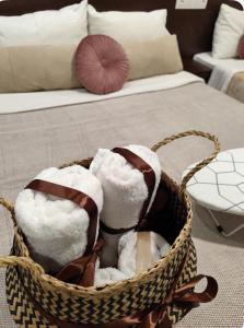 a basket filled with towels in a room with a couch at Filippos studios in Leptokaria