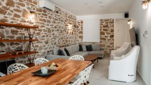 a living room with a table and a couch at Bluevera seafront villa-Aidipsos bay in Gialtra