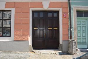 a brown door of a brick building with aphalt at Apartments 163/I in Jindřichŭv Hradec