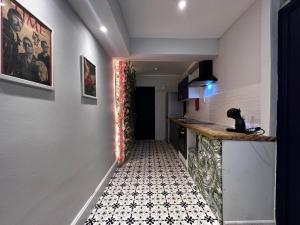 a hallway with a tile floor in a house at Rest Boutique Acton in London
