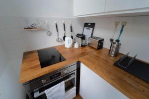 a kitchen with a wooden counter top with a microwave at Beautiful old building apartment in Dresden