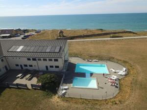 an overhead view of a building with a pool and the ocean at Apartment Lenya - 150m from the sea by Interhome in Løkken +14 photos