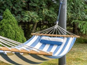 a blue and white hammock with towels in a yard at Holiday Home Dimo - 700m from the sea by Interhome in Løkken