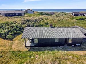 an aerial view of a house on the beach at Holiday Home Tulir - 300m from the sea by Interhome in Løkken