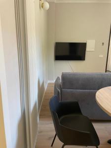 a living room with a couch and a table at Vivic Home Monforte in Monforte dʼAlba