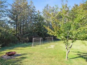 a soccer field with a goal in the grass at Holiday Home Aniki - 1-4km from the sea by Interhome in Løkken
