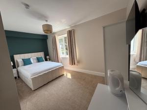 a bedroom with a bed and a large window at East Halton Hotel in East Halton