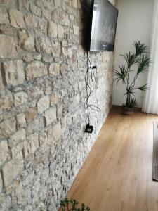 a room with a stone wall and a wooden floor at CasaSicóVista in Pombal